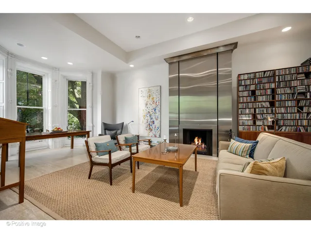 a workspace with furniture fire place and a fireplace