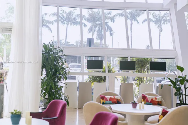 a dining room with furniture and a floor to ceiling window