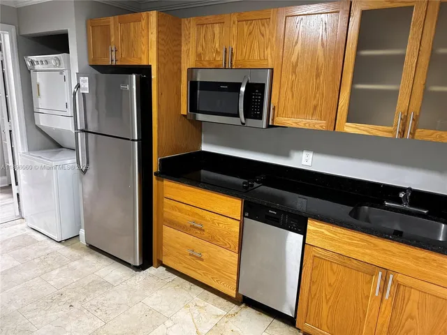 a kitchen with stainless steel appliances a refrigerator and a microwave