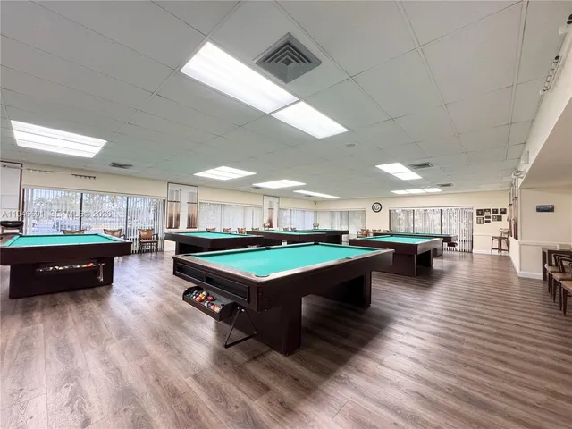 a room with lots of furniture and a wooden floor