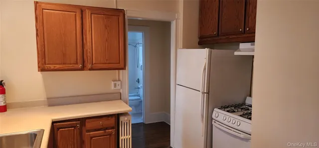 a kitchen with metallic refrigerator freezer and a dishwasher