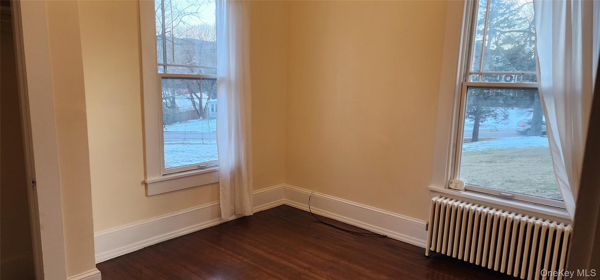 41 Oakland Avenue, Unit # 2 Warwick, NY 10990 - Photo 5 of 9 an empty room with wooden floor and windows