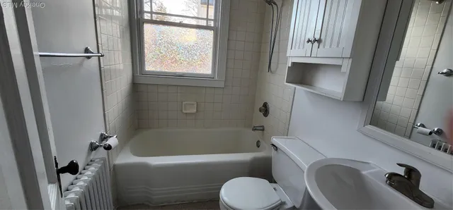 a bathroom with a sink a toilet and bathtub