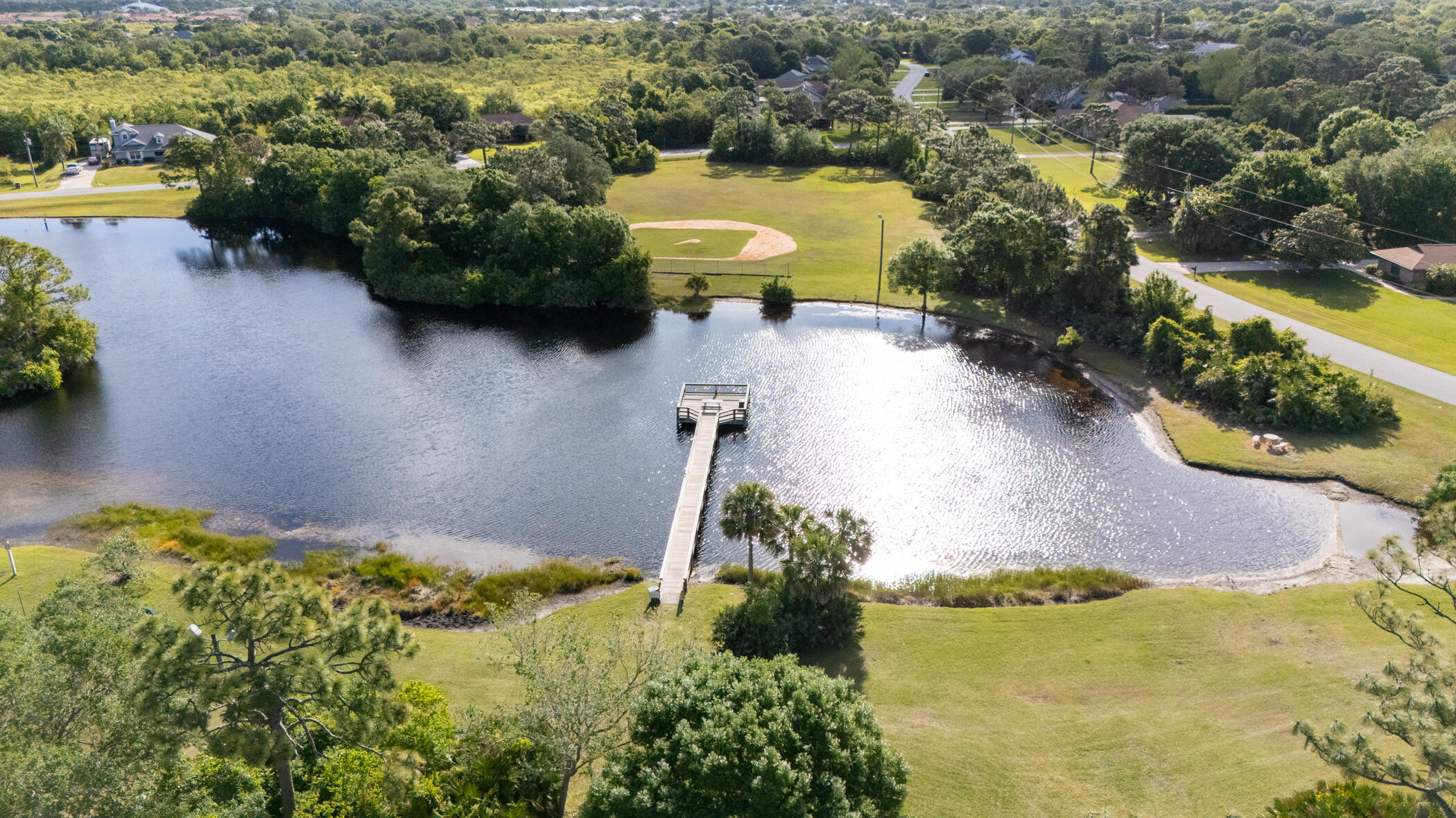 4179 Sparrow Hawk Road Melbourne, FL 32934 - Photo 14 of 26 an aerial view of a house with a yard and lake view