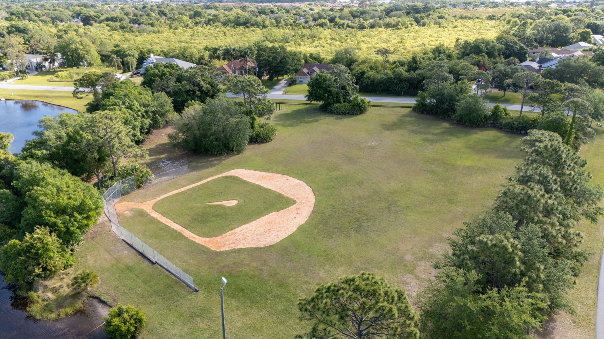 4179 Sparrow Hawk Road Melbourne, FL 32934 - Photo 15 of 26 a view of a lake with a yard
