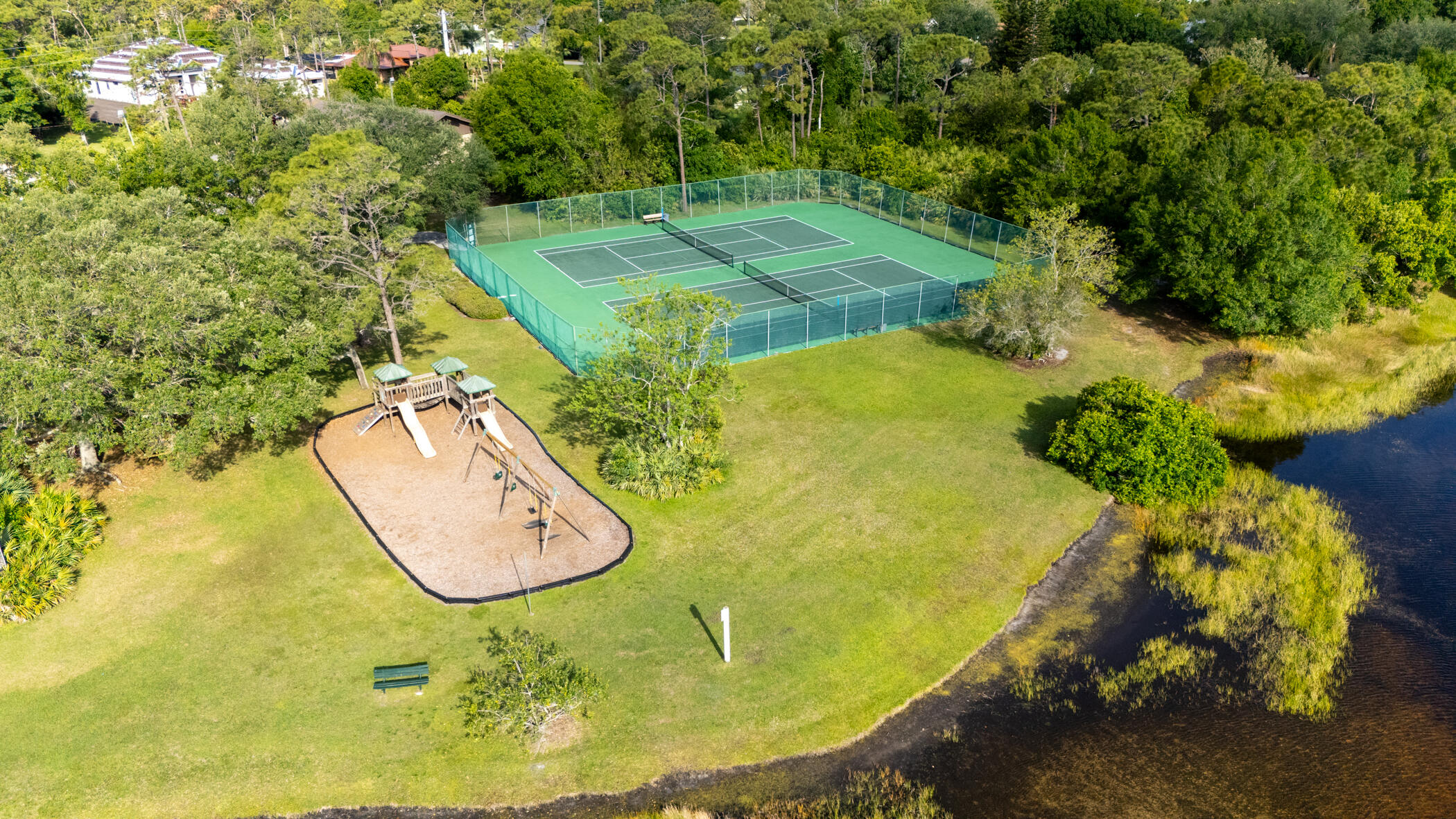 4179 Sparrow Hawk Road Melbourne, FL 32934 - Photo 18 of 26 a view of a swimming pool in he middle of the green