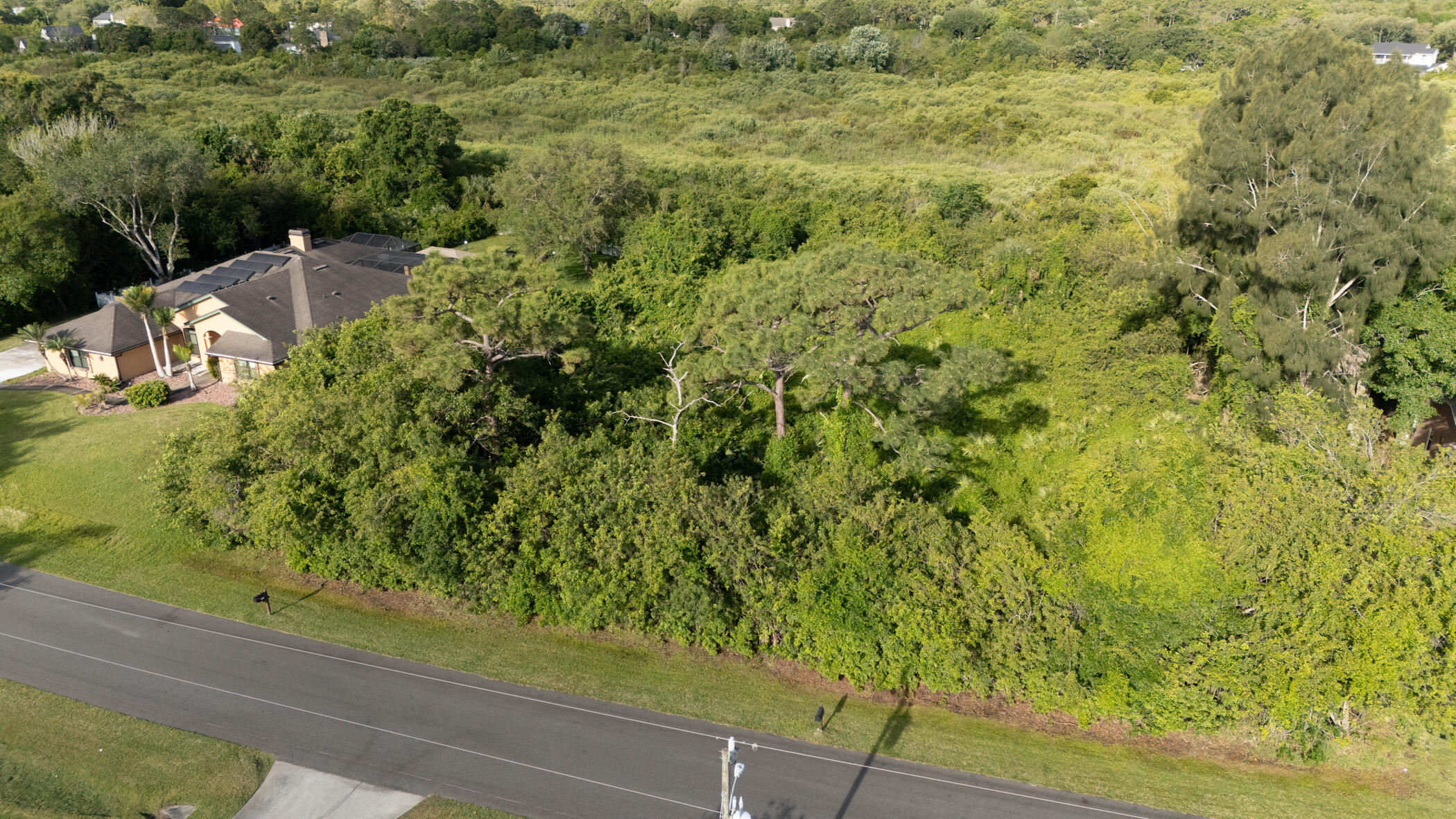 4179 Sparrow Hawk Road Melbourne, FL 32934 - Photo 2 of 26 a view of a yard with plants and wooden fence