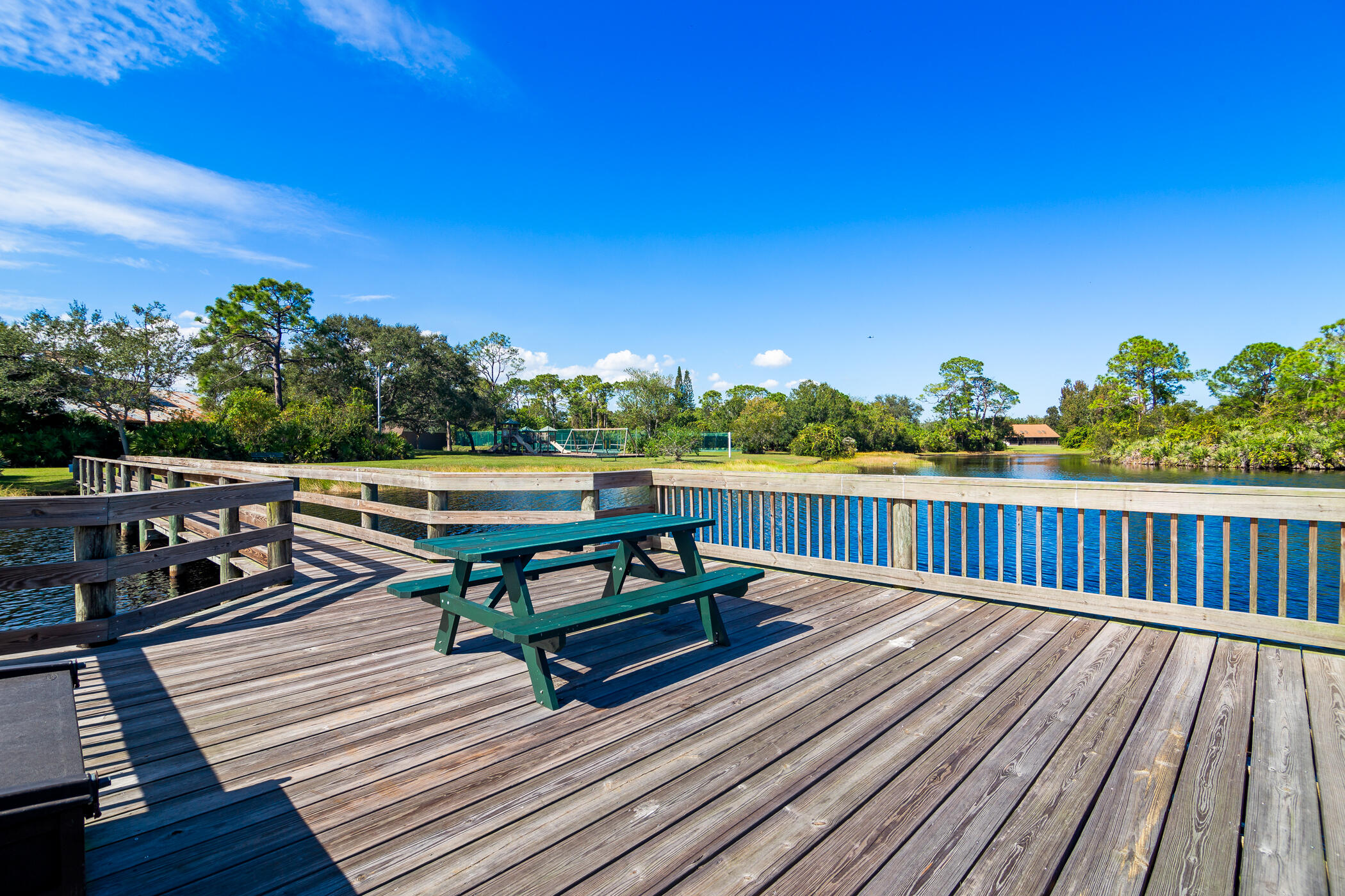 4179 Sparrow Hawk Road Melbourne, FL 32934 - Photo 22 of 26 a view of deck with a table and chairs a barbeque with wooden floor and fence