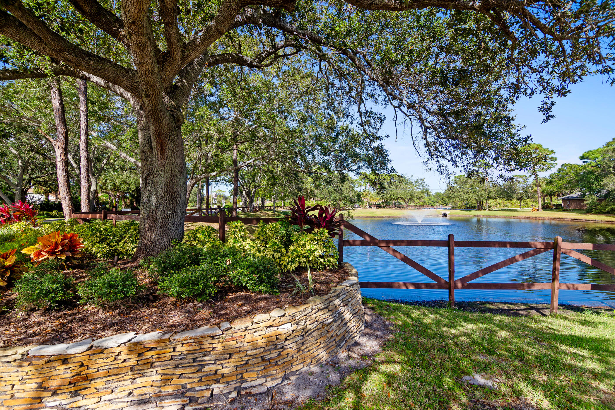 4179 Sparrow Hawk Road Melbourne, FL 32934 - Photo 24 of 26 a view of a backyard with wooden fence and a bench