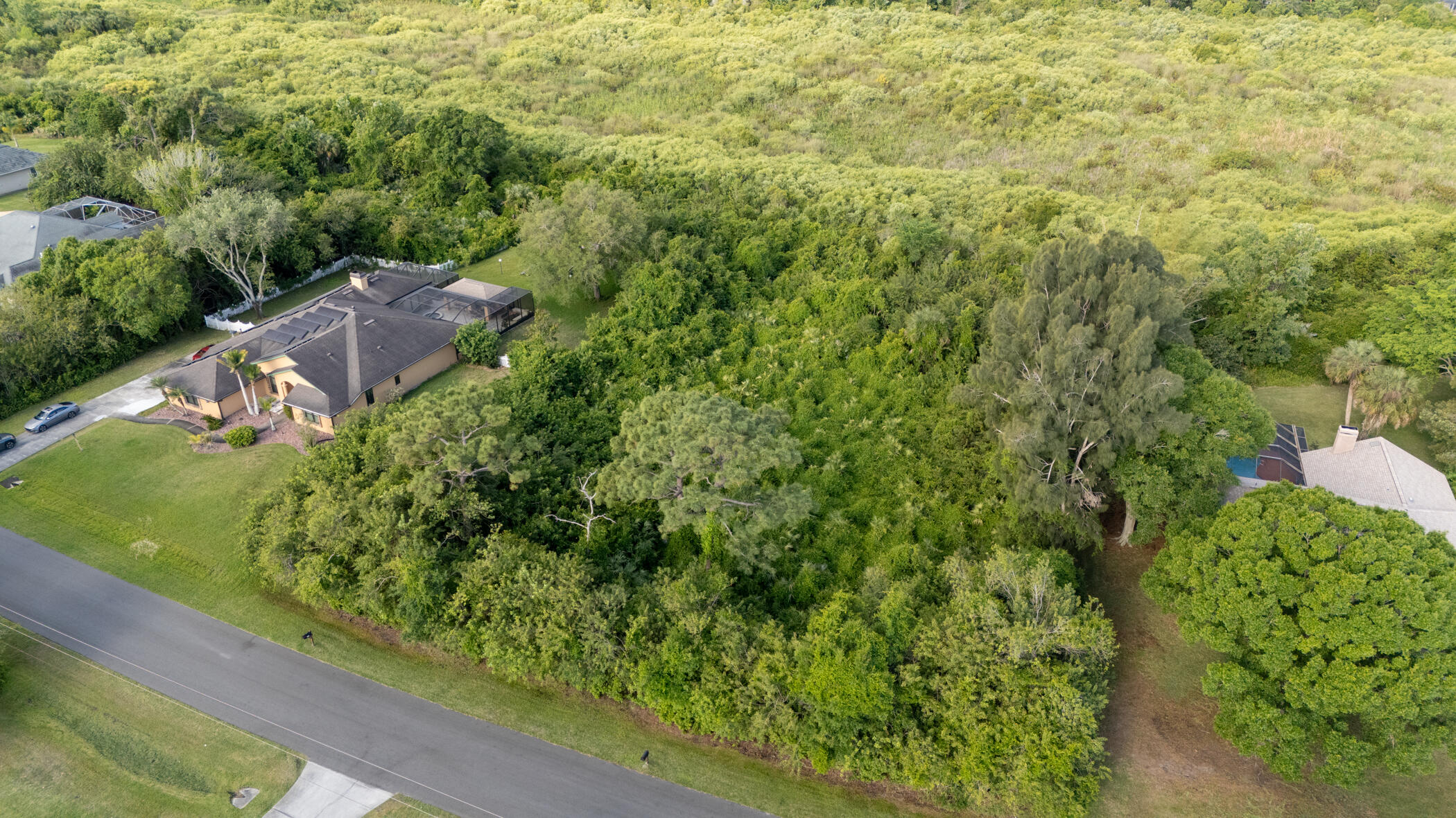 4179 Sparrow Hawk Road Melbourne, FL 32934 - Photo 6 of 26 a view of a garden with a building in the background