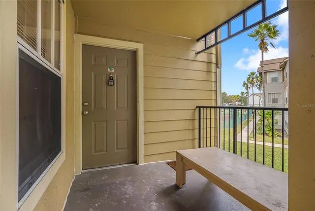 a view of a city with tall buildings and a cars park side of a road