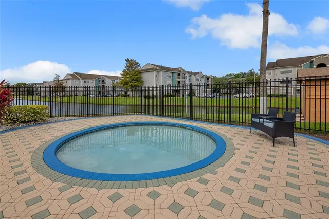 a view of a backyard with swimming pool