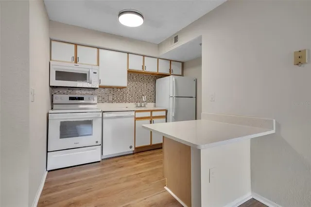 a kitchen with a stove a sink and a refrigerator