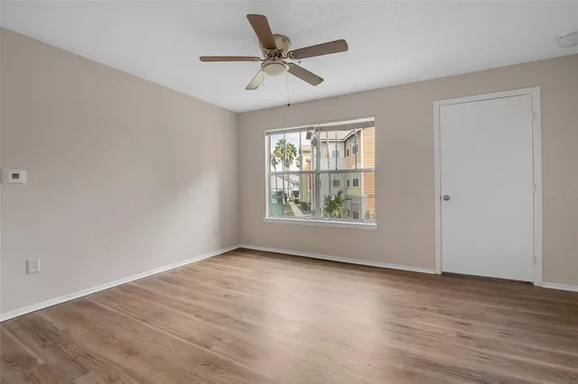 wooden floor in an empty room with a window
