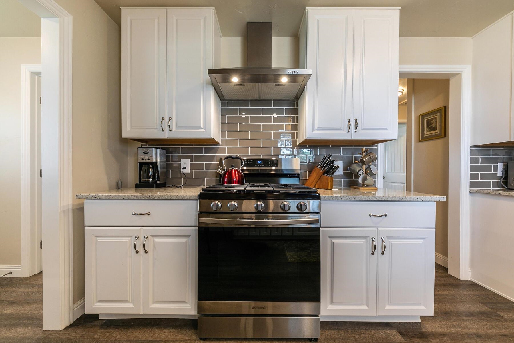94101 Highway 70 Chilcoot, CA 96105 - Photo 15 of 20 a kitchen with stainless steel appliances granite countertop white cabinets and a stove