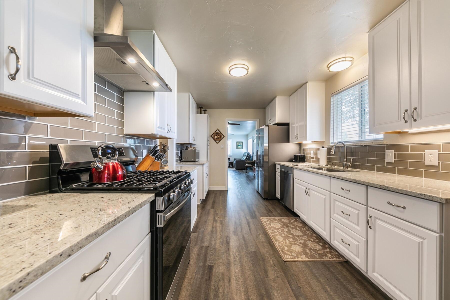 94101 Highway 70 Chilcoot, CA 96105 - Photo 16 of 20 a kitchen with stainless steel appliances granite countertop lots of counter top space and wooden floor