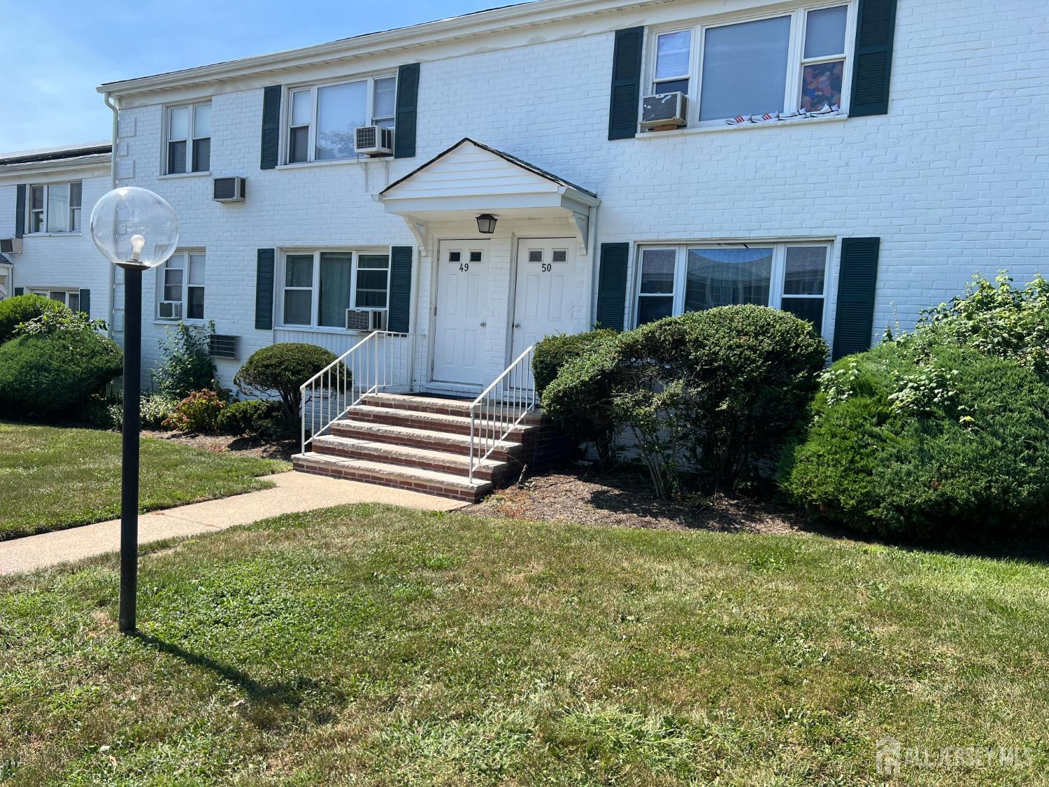 49 B Garfield Park, Unit 4902 Edison, NJ 08837 - Photo 1 of 10 a front view of a house with garden