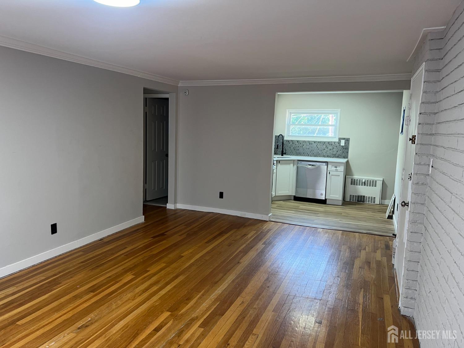 49 B Garfield Park, Unit 4902 Edison, NJ 08837 - Photo 3 of 10 a view of a room with wooden floor and a sink