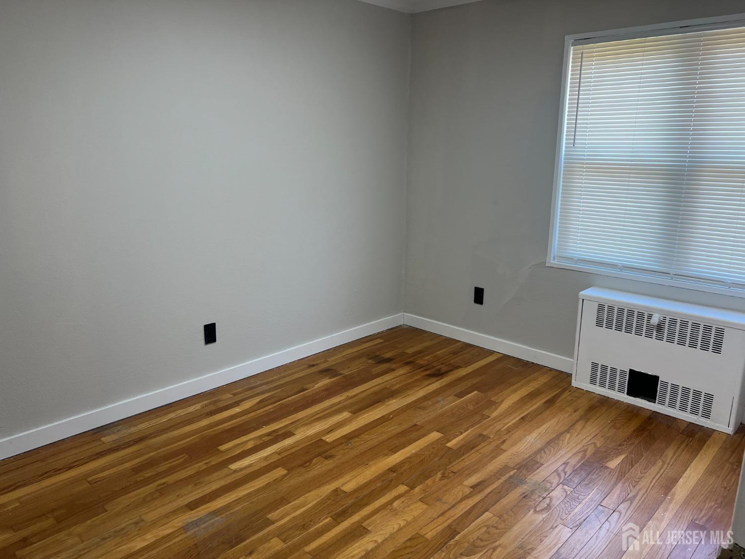 49 B Garfield Park, Unit 4902 Edison, NJ 08837 - Photo 7 of 10 a view of a room with wooden floor and a window