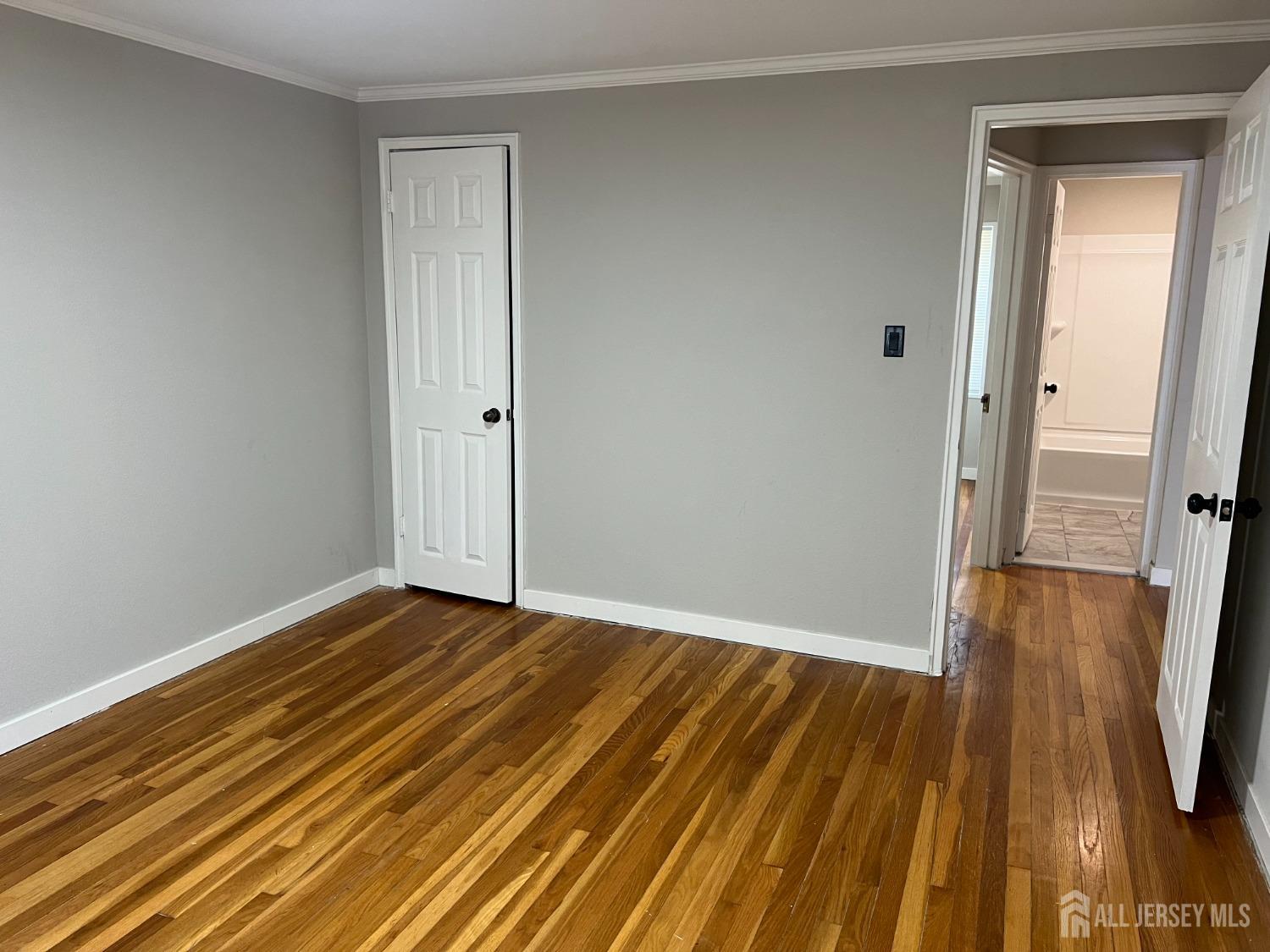 49 B Garfield Park, Unit 4902 Edison, NJ 08837 - Photo 9 of 10 a view of a room with wooden floor and a bathroom