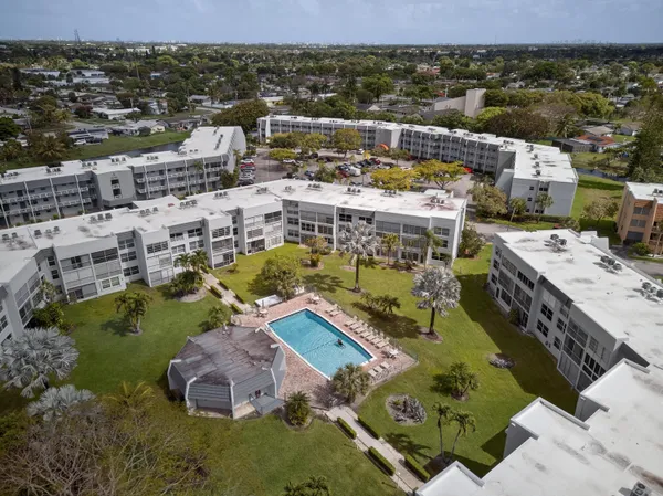 an aerial view of a house with a swimming pool yard and lake view
