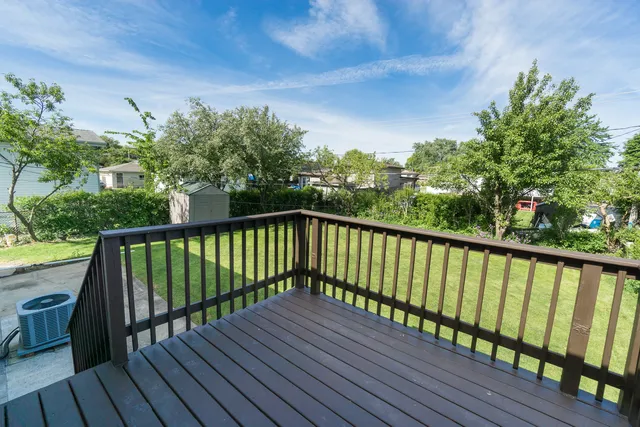 a balcony with wooden floor and fence