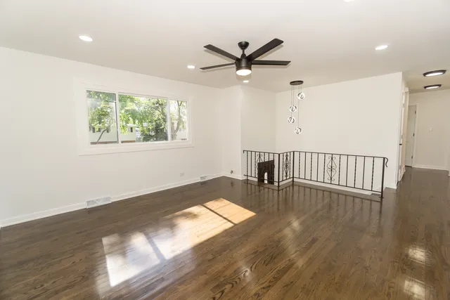 a view of wooden floor and windows in a room