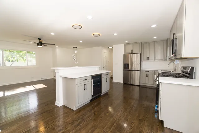 a kitchen with a stove a refrigerator and a sink