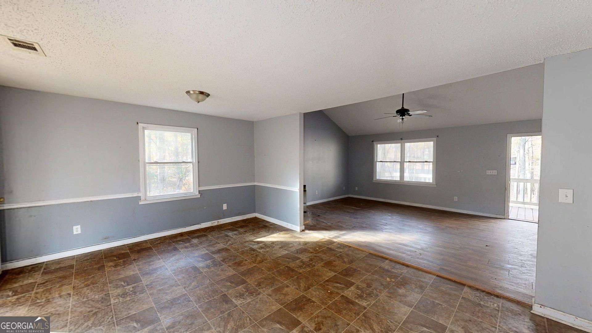 1225 Coppermine Road Buchanan, GA 30113 - Photo 11 of 29 a view of an empty room with a window and wooden floor