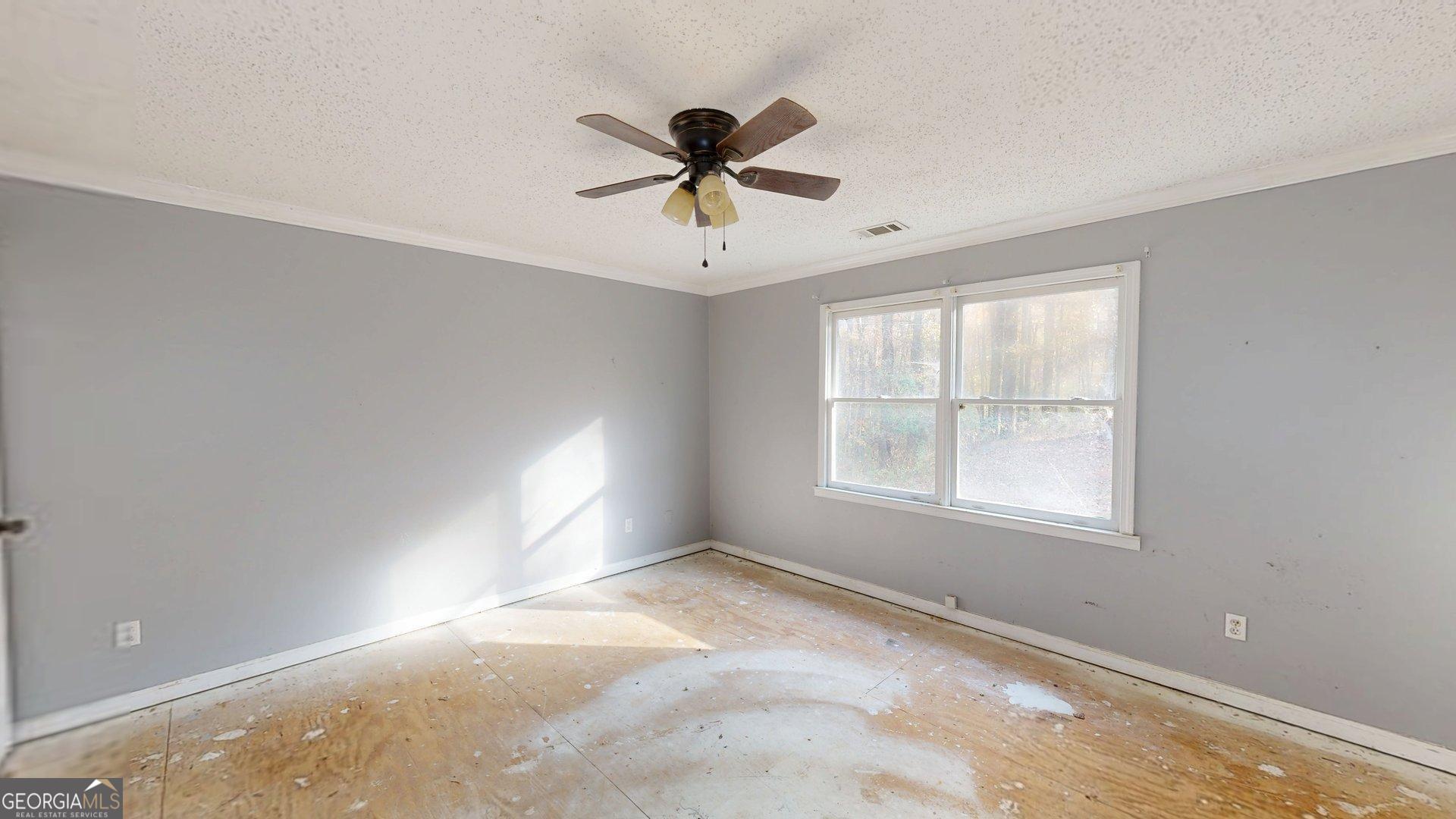 1225 Coppermine Road Buchanan, GA 30113 - Photo 12 of 29 an empty room with windows and fan