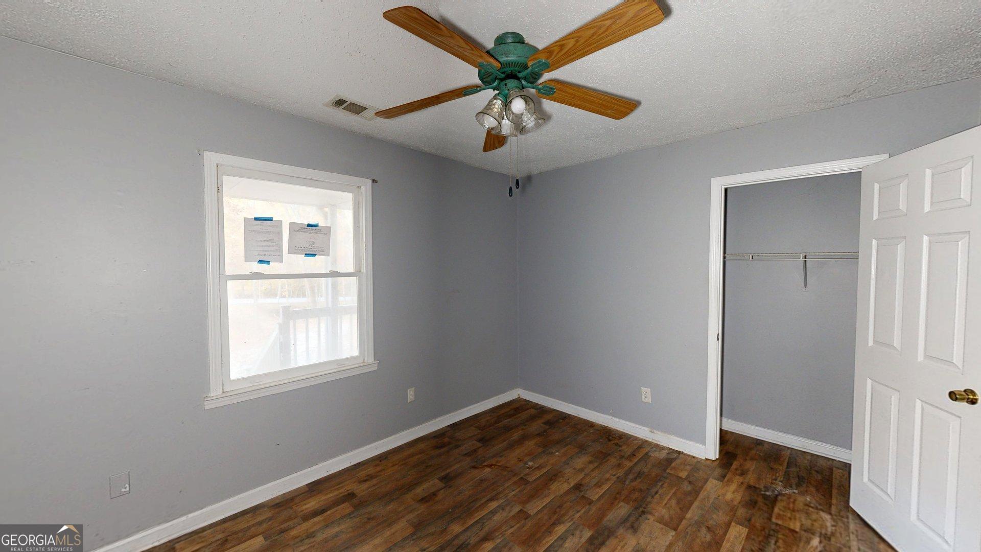 1225 Coppermine Road Buchanan, GA 30113 - Photo 18 of 29 wooden floor in an empty room with a window