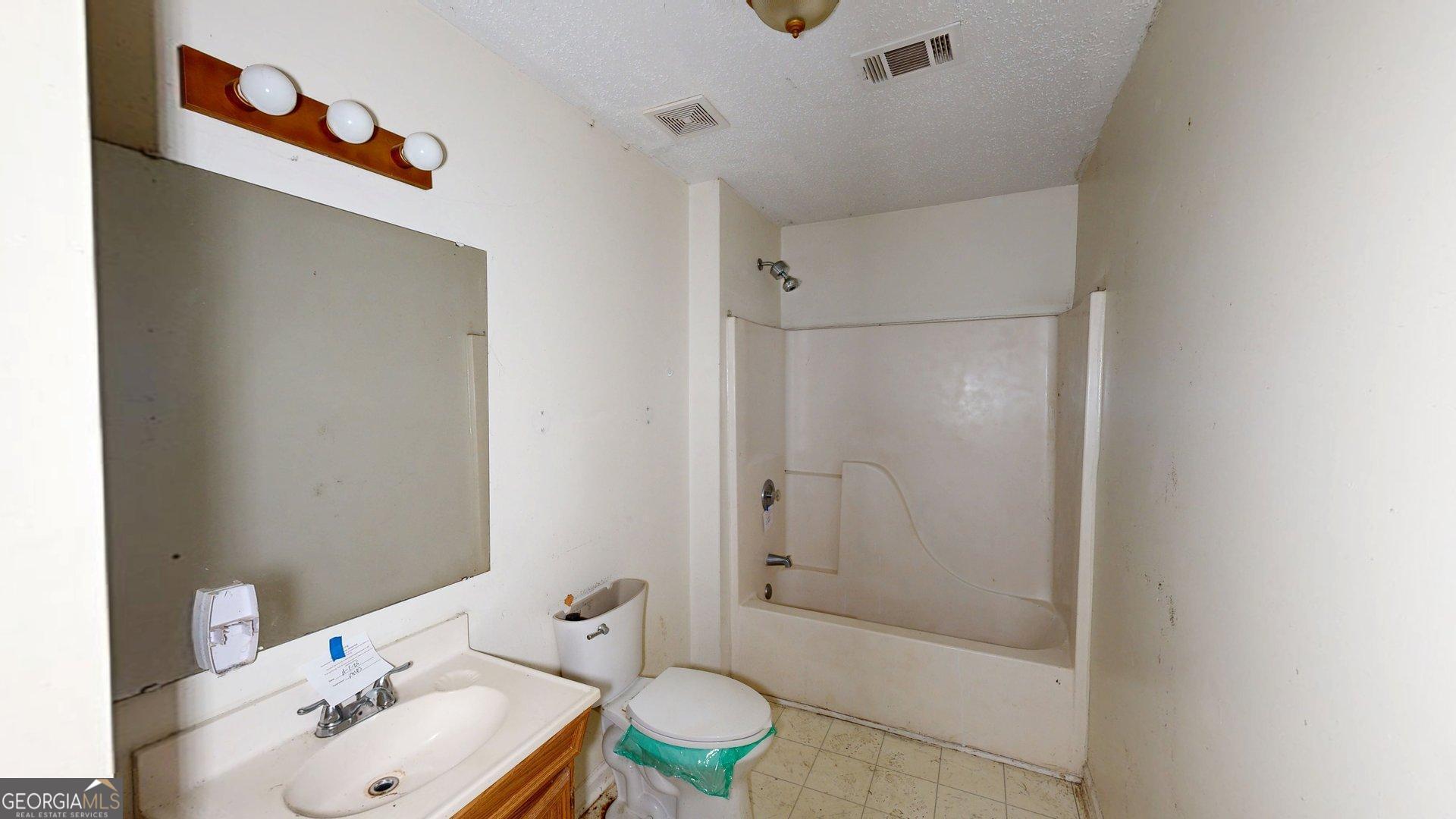1225 Coppermine Road Buchanan, GA 30113 - Photo 20 of 29 a bathroom with a sink a toilet and shower