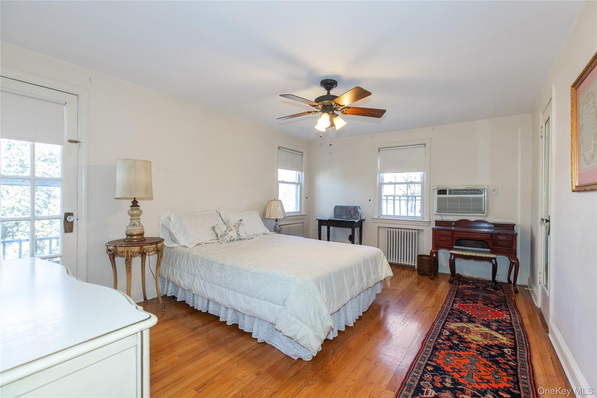 8 Plymouth Road Great Neck, NY 11023 - Photo 18 of 25 a bedroom with bed and a table