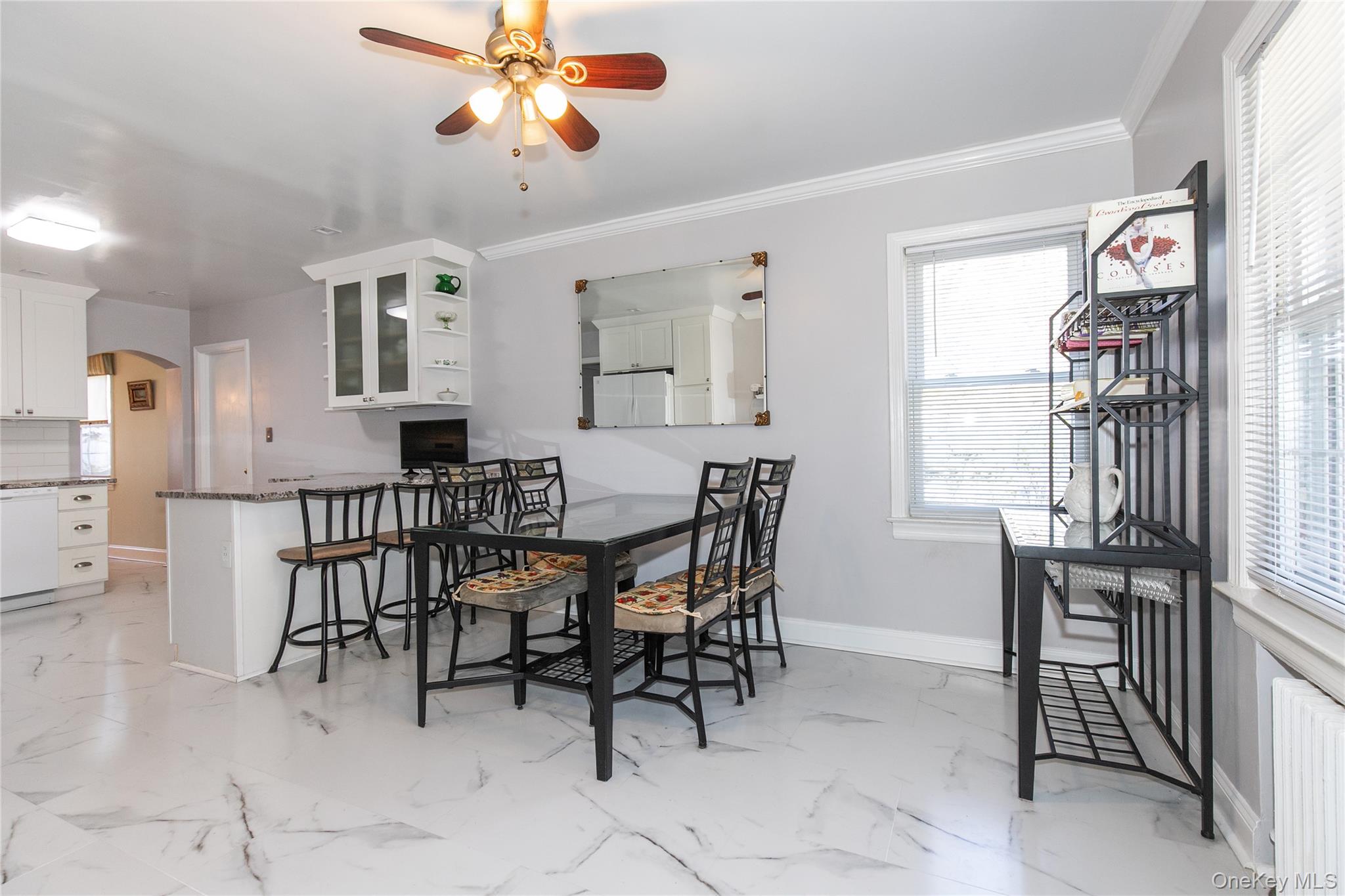 8 Plymouth Road Great Neck, NY 11023 - Photo 8 of 25 a view of a dining room with furniture and a chandelier