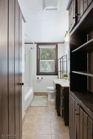 a bathroom with a bathtub a sink and a large mirror