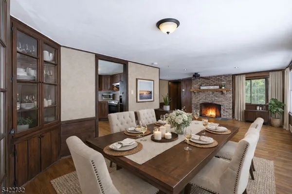 a dining room with furniture a table and a fireplace