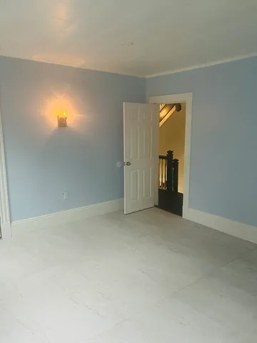 an empty room with closet and windows