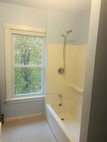 a bathroom with a bath tub and a shower