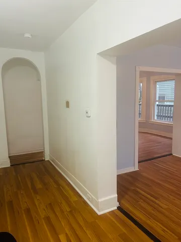 a view of a room with wooden floor and white walls
