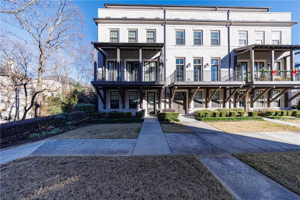 2067 Wheaton Way Atlanta, GA 30328 - Photo 2 of 64 a view of a brick building with many windows