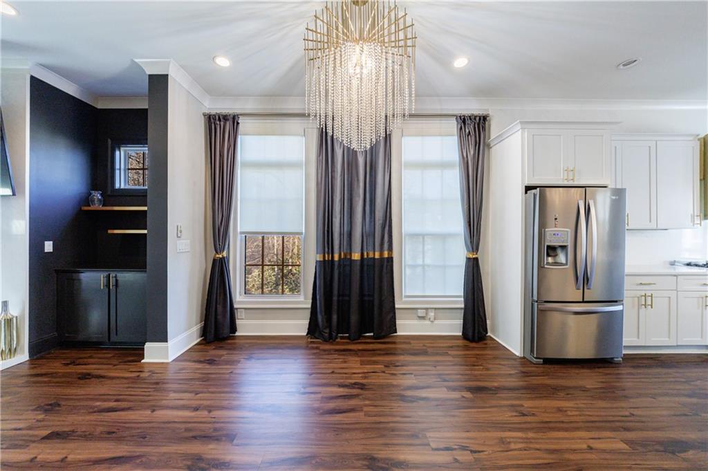 2067 Wheaton Way Atlanta, GA 30328 - Photo 22 of 64 a view of a kitchen with wooden floor and refrigerator