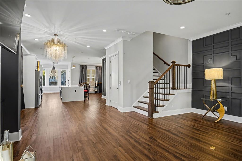 2067 Wheaton Way Atlanta, GA 30328 - Photo 23 of 64 a living room with furniture floor to ceiling window and wooden floor