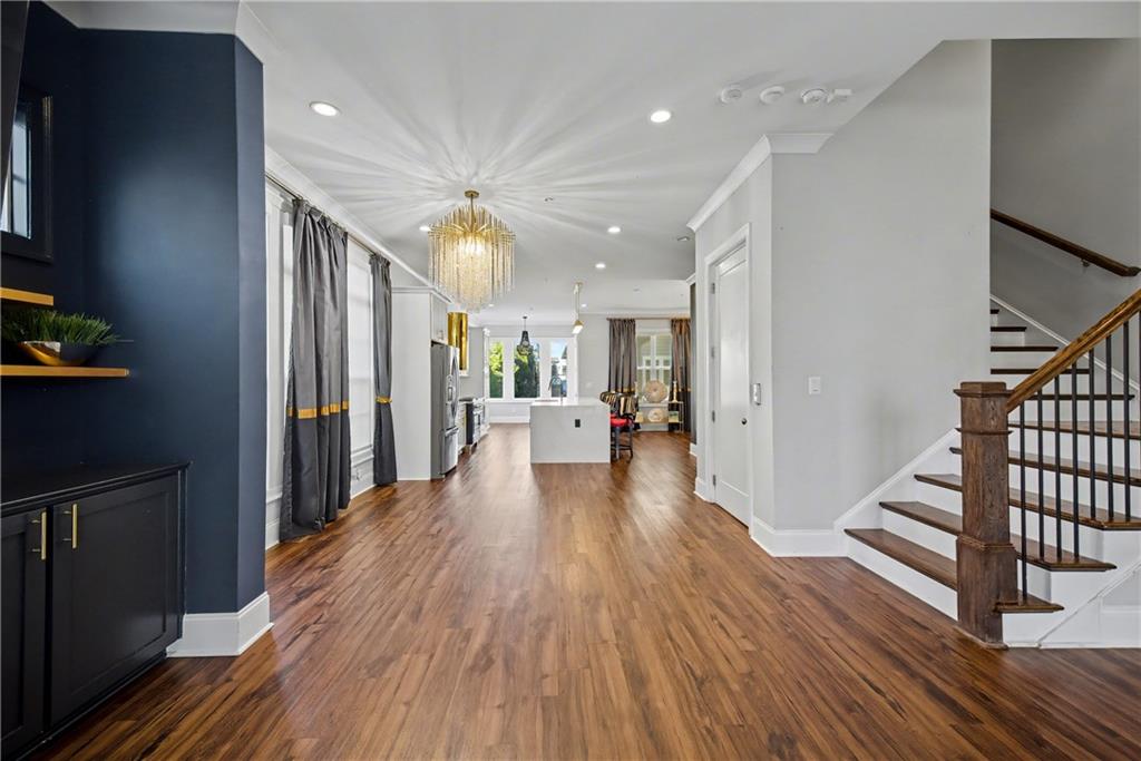 2067 Wheaton Way Atlanta, GA 30328 - Photo 24 of 64 a view of a hallway with wooden floor and staircase