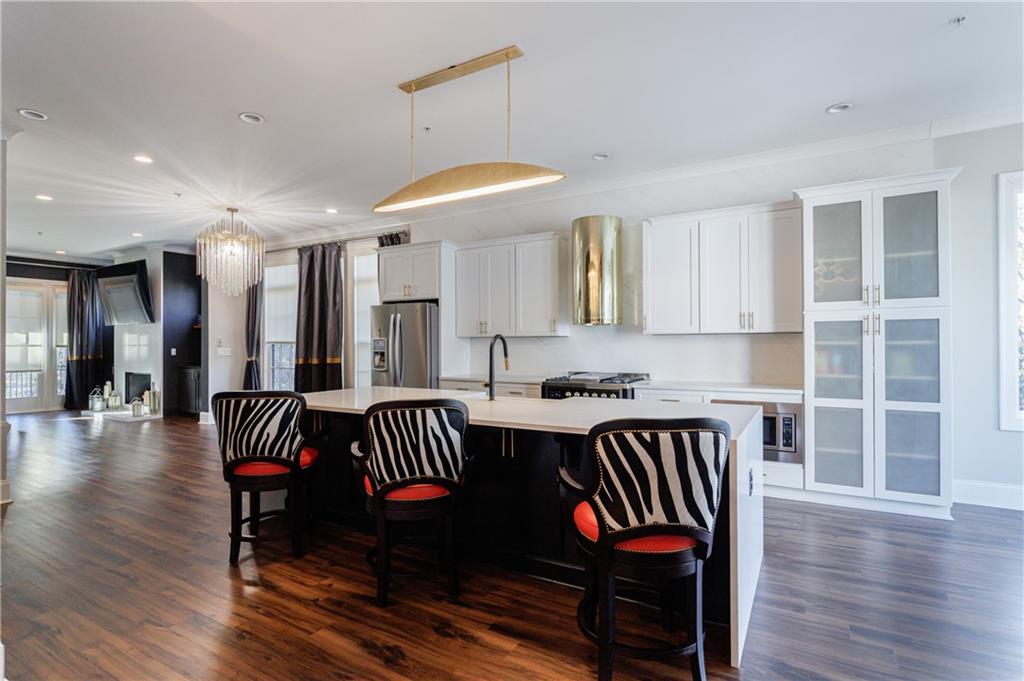 2067 Wheaton Way Atlanta, GA 30328 - Photo 25 of 64 a view of kitchen and dining room with wooden floor