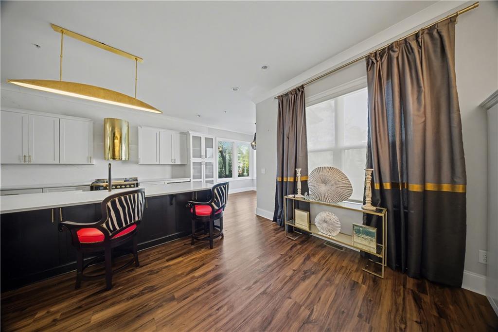 2067 Wheaton Way Atlanta, GA 30328 - Photo 29 of 64 a living room with furniture stairs and a wooden floor