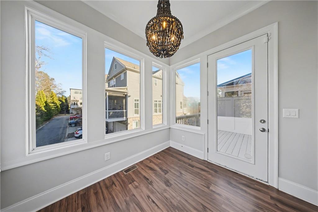 2067 Wheaton Way Atlanta, GA 30328 - Photo 35 of 64 a view of an empty room with wooden floor and a window