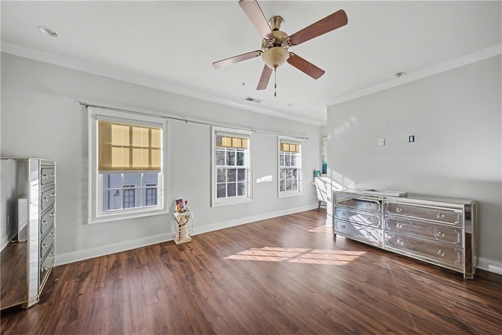 2067 Wheaton Way Atlanta, GA 30328 - Photo 38 of 64 a view of an empty room with a window and wooden floor