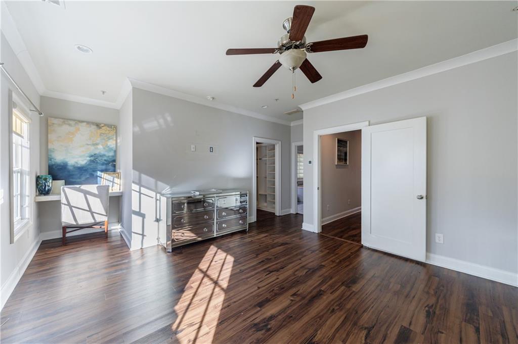 2067 Wheaton Way Atlanta, GA 30328 - Photo 39 of 64 a view of a livingroom with hardwood floor and a ceiling fan