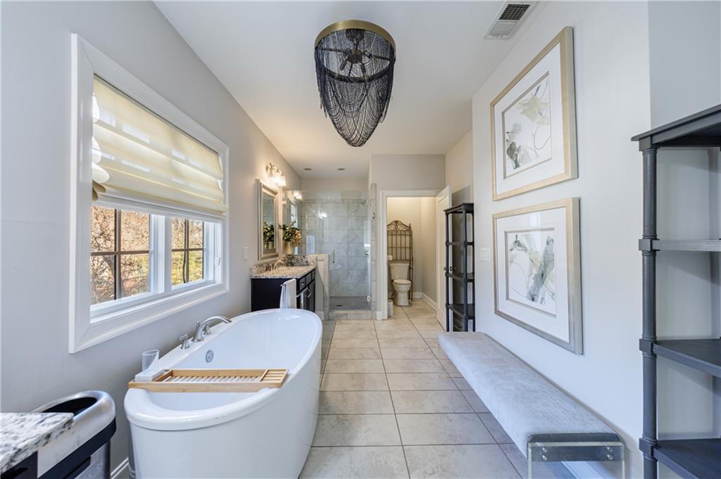 2067 Wheaton Way Atlanta, GA 30328 - Photo 41 of 64 a bathroom with a toilet a sink and a window