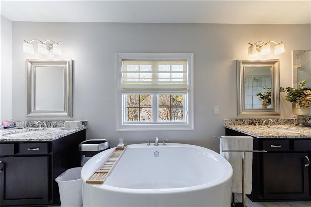 2067 Wheaton Way Atlanta, GA 30328 - Photo 42 of 64 a white bath tub sitting next to a white sink
